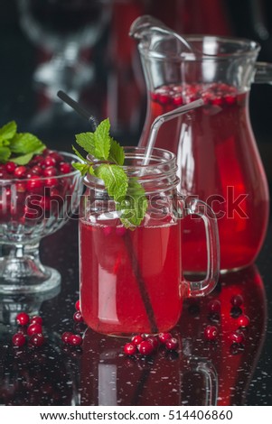 Fresh cranberry juice with mint on black background