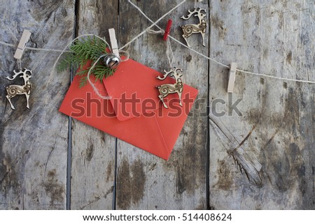 Letter to Santa Claus in Red Envelope, Hanging on Garland with Deers