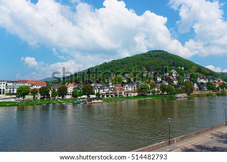 Embankemnt of Neckar river in Heidelberg in  Baden-Wurttemberg in Germany. People on the background