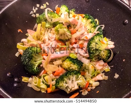 Asian meal with chicken and vegetables cooked in wok pan 
Healthy dinner for low carb diet, fresh and tasty. Image for cook book, food business concept, blog, website, menue card