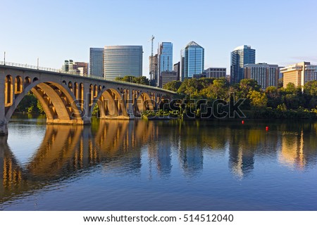 Key Bridge and Rosslyn skyline in early morning, Washington DC, USA. A view n Potomac River from Georgetown Park in US capital. Royalty-Free Stock Photo #514512040
