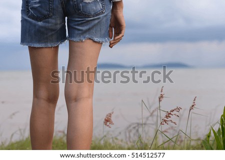 woman is watching the rain in the sea