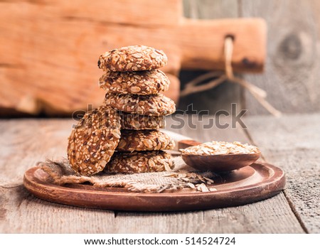 Oatmeal cookies on burlap and rustic wooden table