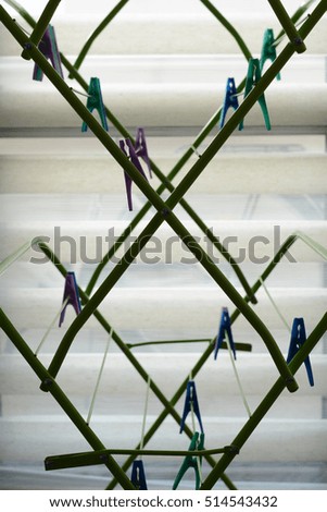 hanging clothespins, art of clothespin, Colored clothes pins on a white background, clothes pins. Concept of housework and laundry.