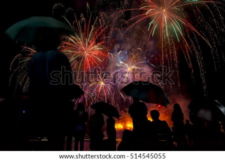 peoples in silhouette enjoy watching firework show celebrating new year