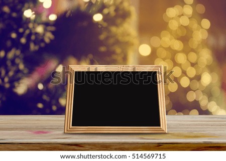 photo frames on wooden table with abstract christmas light night background