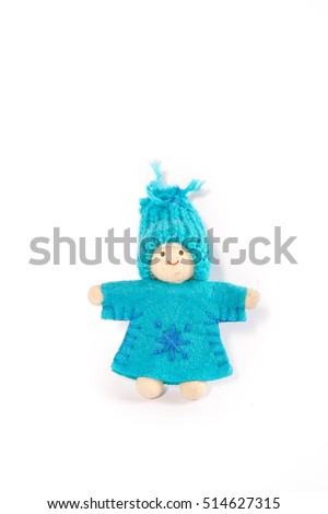 handmade waldorf dwarf doll with snowflake symbol on her dress isolated on a white background. Art and crafts, closeup. Christmas or Valentine's day background.
