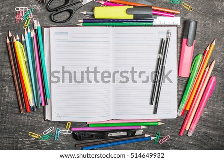 School supplies on blackboard background, top view, copy space