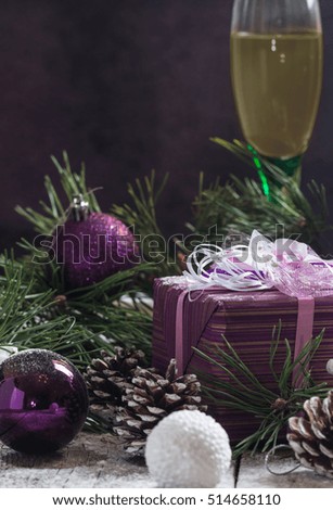 Christmas background with gift and festive decoration of balls and pine cones