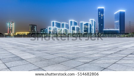 Panoramic empty floor with modern business office building at night