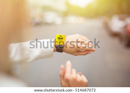 Woman calling taxi using her smartwatch Royalty-Free Stock Photo #514687072