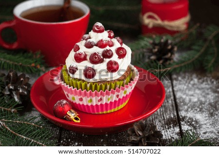 Christmas cupcakes with whipped cream topping and cranberries. Christmas festive food dessert.