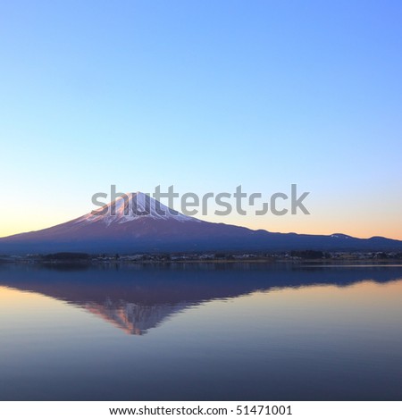 mountain Fuji at dawn with peaceful lake