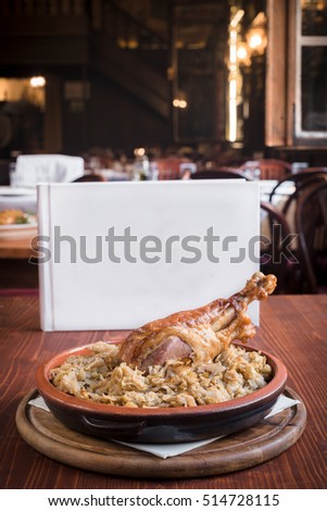 Turkey drumstick and cooked cabbage in restaurant,selective focus and empty space 