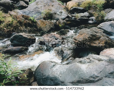 Water fast stream flowing among stones