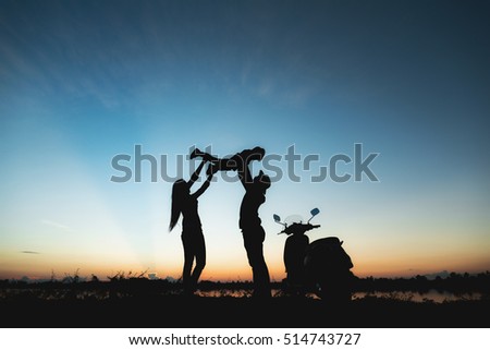 image of happy family joyful,father mother and son playing at sunset time,jovial happiness playful silhouette concept.