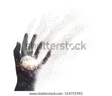 Magical transformation image of dust and particles flying out of hand, combined with photograph of clocks . Abstract symbol of time and death, hope renewal or reborn and reincarnation. Isolated  Royalty-Free Stock Photo #514751992