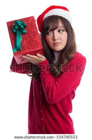 Happy woman wearing christmas santa hat  with christmas gift box, wondering and thinking  what is inside the gift box, isolated on white background