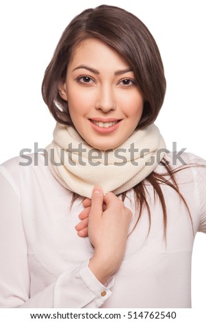 Young beautiful happy fashion model with scarf and hat. isolated on white, studio shot.
