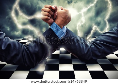 Businessman Competing In Arm Wrestling on lightning storm effect background