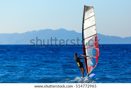 Recreational Water Sports. Windsurfing. Windsurfer Surfing The Wind On Waves In Ocean, Sea. Extreme Sport Action. Recreational Sporting Activity. Healthy Active Lifestyle. Summer Fun Adventure. Hobby Royalty-Free Stock Photo #514772965