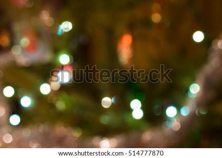 The lights on the Christmas tree in blur zone. Natural background.