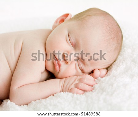 closeup picture of a newborn baby's face while it is sleeping