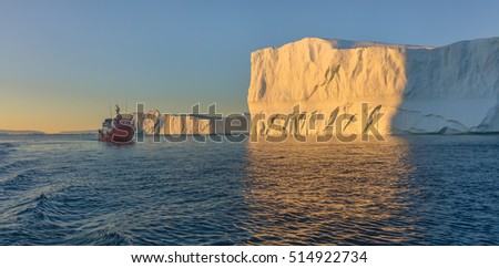 Tourists take pictures of the iceberg. Source of icebergs is by the Jakobshavn glacier. This is a consequence of the phenomenon of global warming and catastrophic thawing of ice, Disko Bay, Greenland