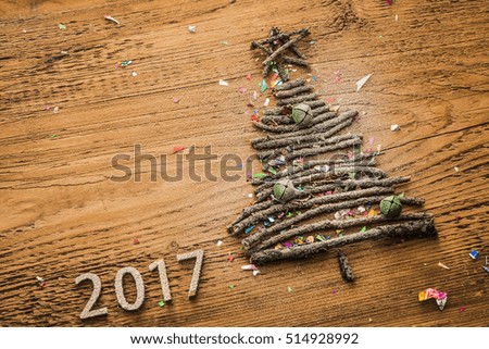 Sign symbol from many dry Stick snowy Christmas Tree a lot colorful star toys on old retro vintage style wooden texture background Empty copy space for inscription Idea of merry new year 2017 holiday