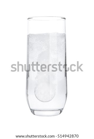 Pill dissolving in glass of water on white background isolated