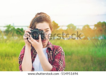 young woman photographer taking at park