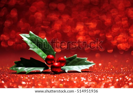 Sprig of holly red glitter background