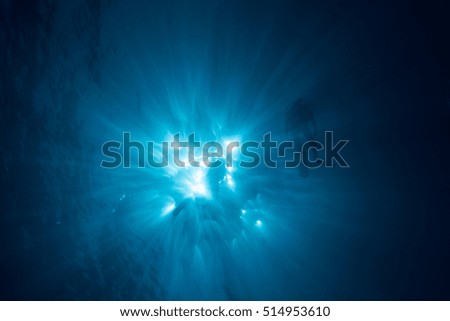 Sunburst and silhouette of a diver underwater