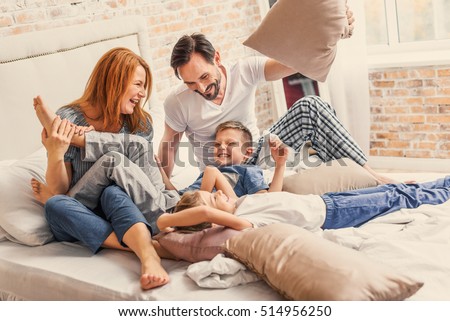 Young family being playful at home Royalty-Free Stock Photo #514956250