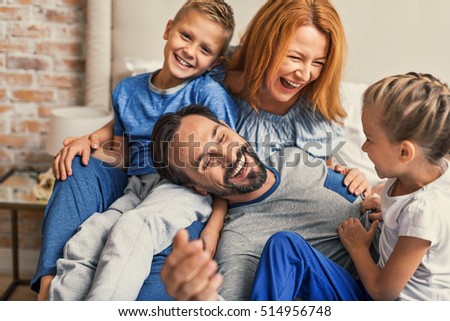 Happy family lying down on bed at home Royalty-Free Stock Photo #514956748