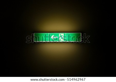 Emergency exit sign glowing in the dark