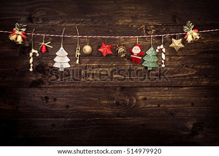 Christmas decoration and hanging on a rope with old wooden background. vintage color tone