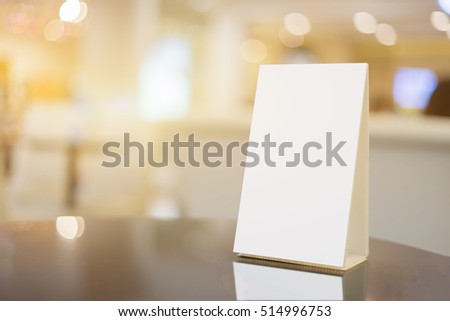 Mock up Menu frame on Table in Bar restaurant ,Stand for booklets with white sheets of paper acrylic tent card on cafeteria blurred background
 Royalty-Free Stock Photo #514996753