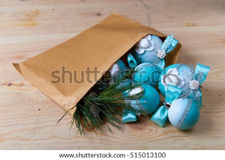 Blue Christmas balls with a cameo in an envelope, a wooden background. 
