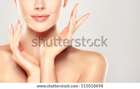 Beautiful Young Woman with Clean Fresh Skin  touch own face . Facial  treatment   . Cosmetology , beauty  and spa . Royalty-Free Stock Photo #515018698