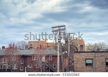 View of the Back Alley with Brick Building, Telephone Pole and Cloudy Sky.