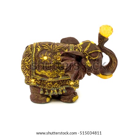 Photo of statuette of brown elephant with yellow sapphire isolated on a white background