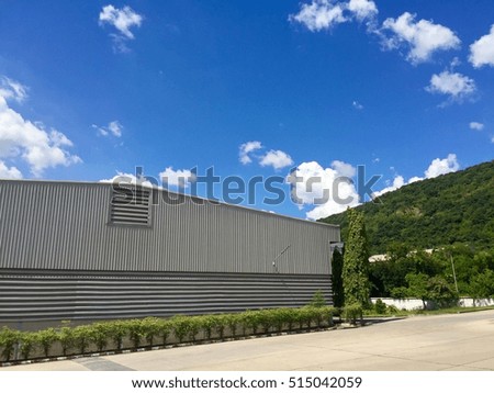 Grey Factory ,green mountain and blue sky background.