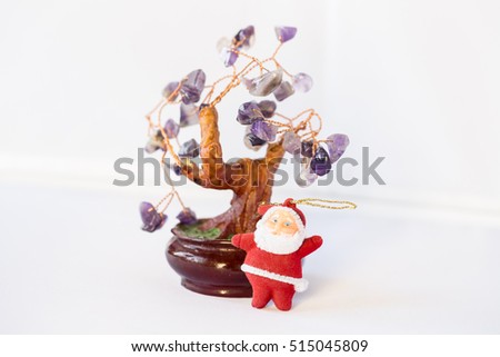 Santa Claus and Christmas tree with leaves of amethyst