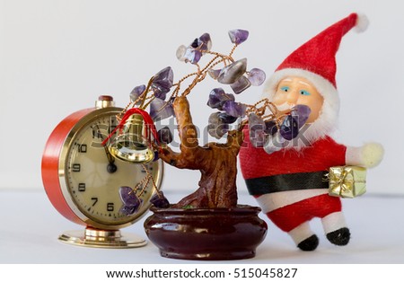 Twelve five minutes and Santa Claus with gifts in hand is standing beside a Christmas tree with leaves of amethyst