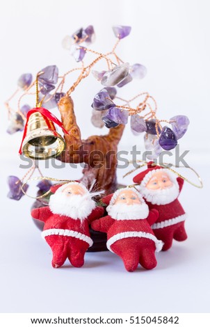 Three Santa Claus and Christmas tree with leaves of amethyst