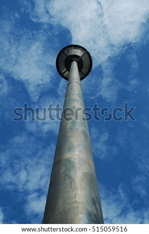 The single light pole with a blue sky background