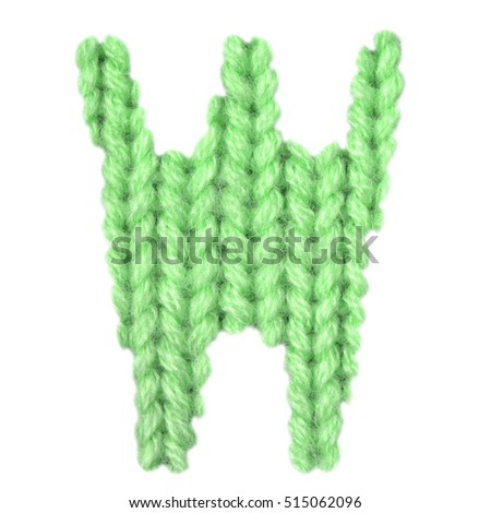 Letter W alphabet on a blurry texture knitted pattern of woolen thread closeup. One letter of the English alphabet. Education and holidays. Typography design. Color green