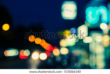 vintage tone image of blur street bokeh with colorful lights in night time for background usage .