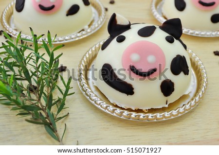 cow cakes decorated and chocolate stars on wood background